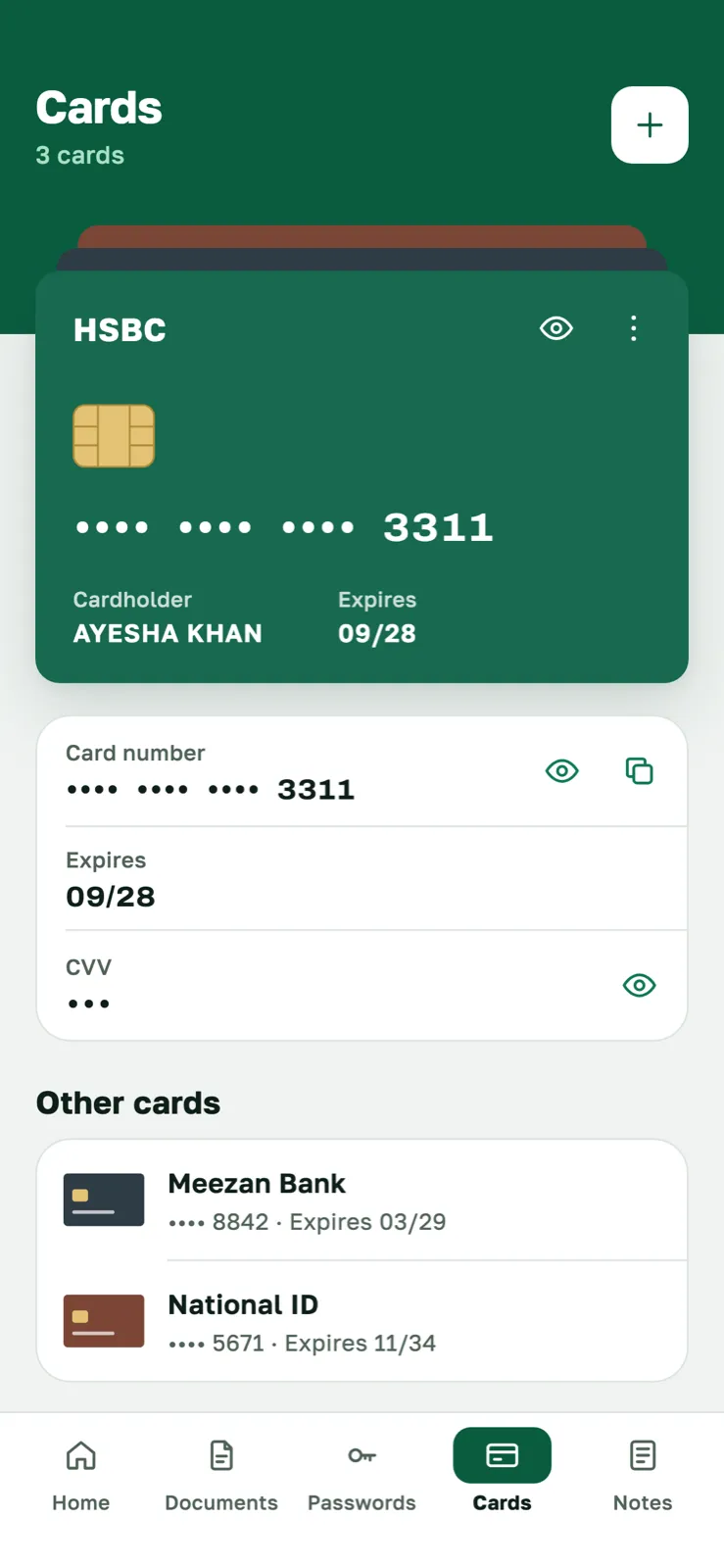 Cards screen showing a bank card with its number hidden, and two more saved cards below it.
